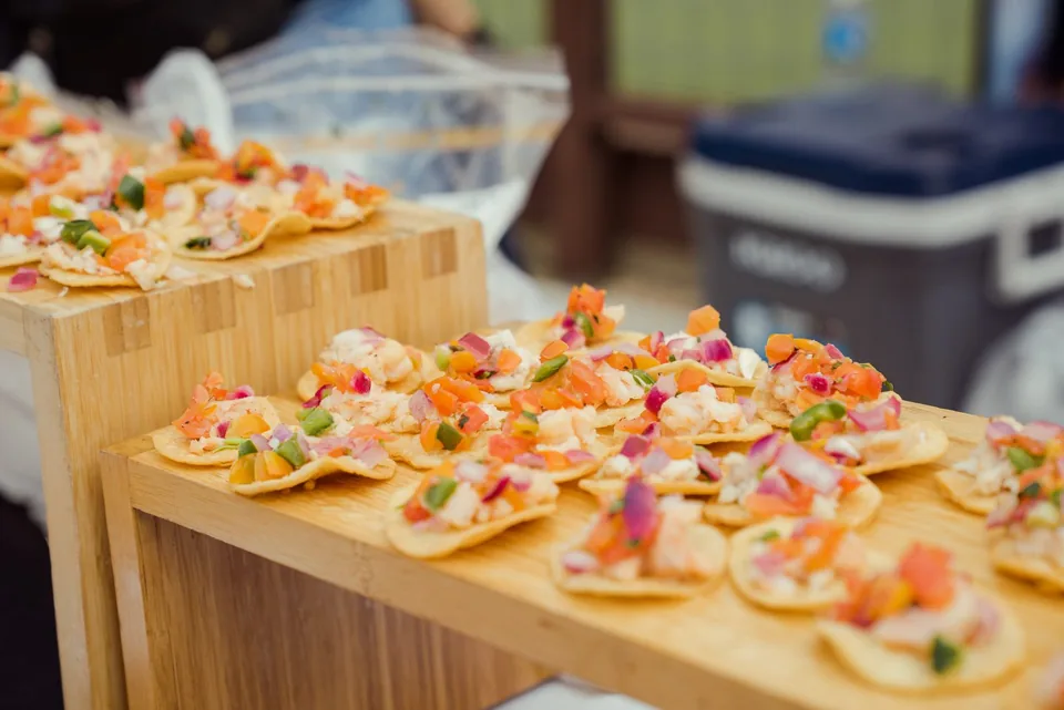 Fresh ceviche tostadas arranged at a festival food booth