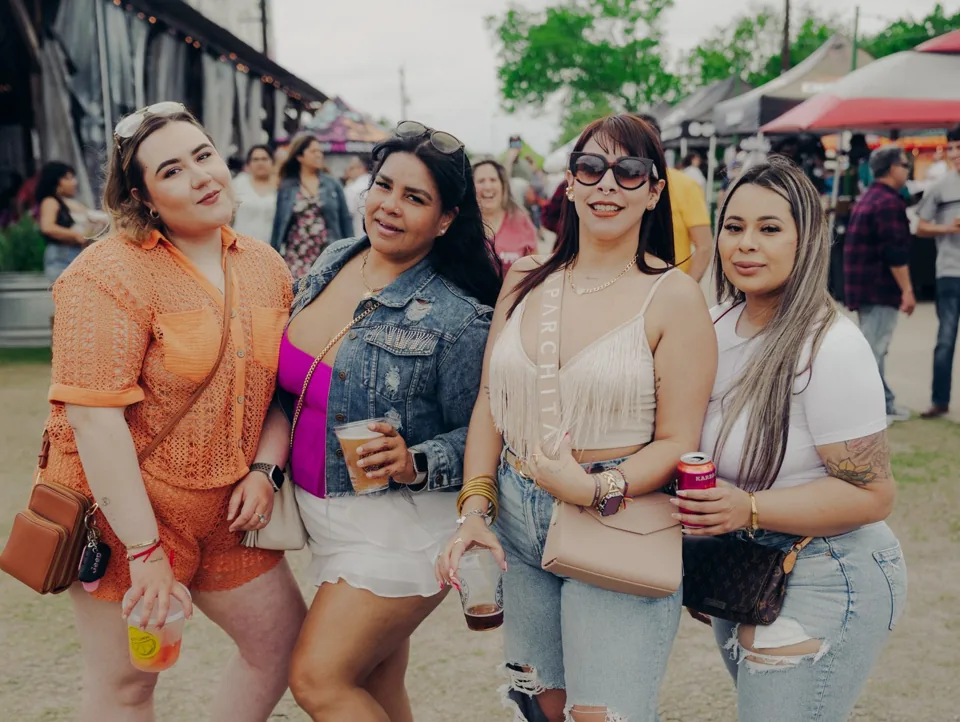 Friends smiling together at Sazón Latin Food Festival