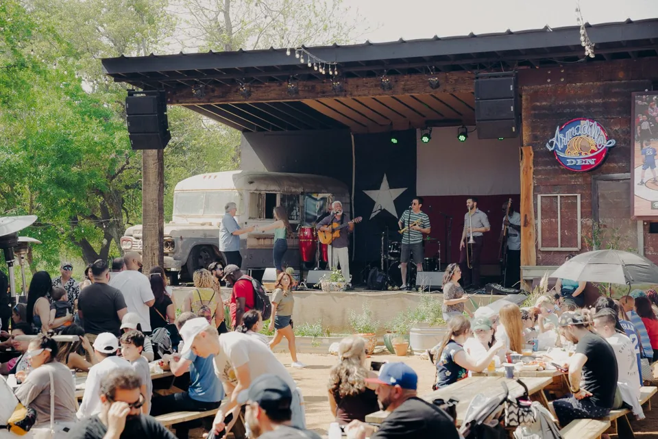 A festival crowd watching a live performance on an outdoor stage