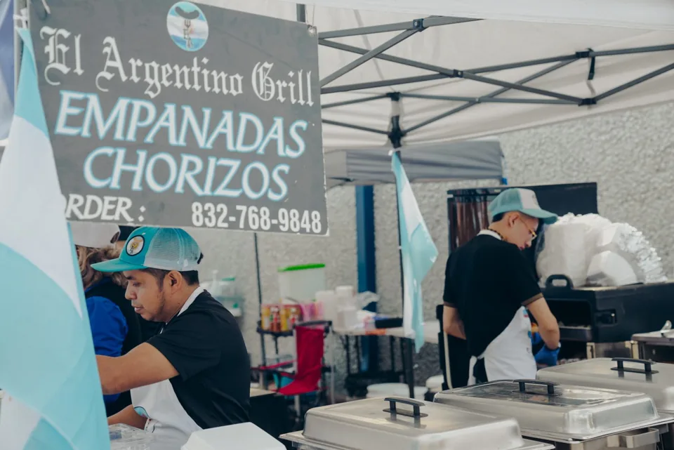 El Argentino Grill vendors preparing food at their festival stand